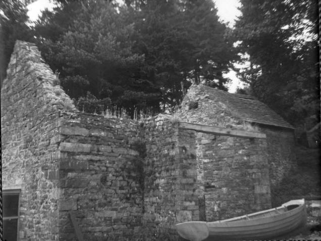 The derelict building that was later converted to become the clubhouse is pictured with a boat stored alongside.